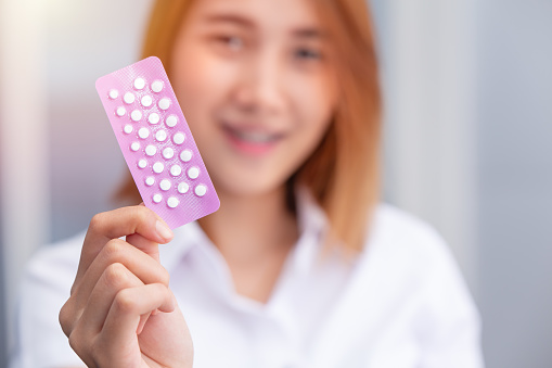 teen girl with birth control pills Combined Oral Contraceptive Pill, COCP show up happy smile