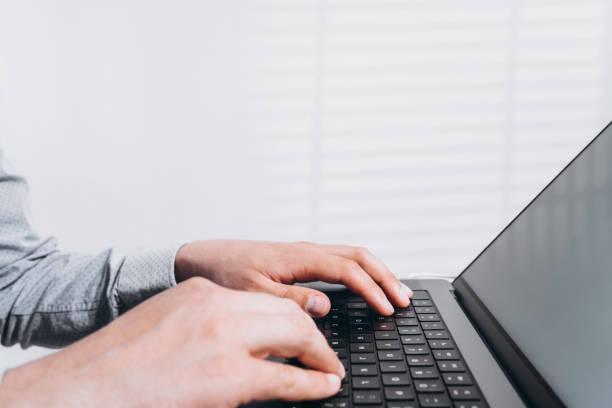 istock Programmer man hands typing on laptop computer keyboard and surfing the internet on office table. Distance learning, working from home, business and technology, internet network communication concept 1439491547