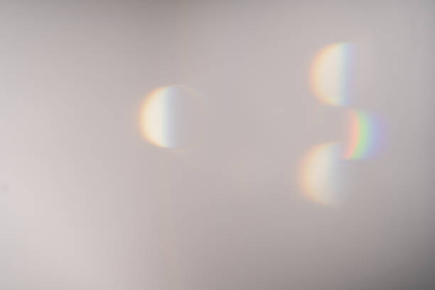 istock Blue light flare prism rainbow flares overlay effect on black background, light crossing crystals, prismatic sun catcher reflections rays. Abstract blurred colourful lens flare bokeh on dark backdrop 1439491572