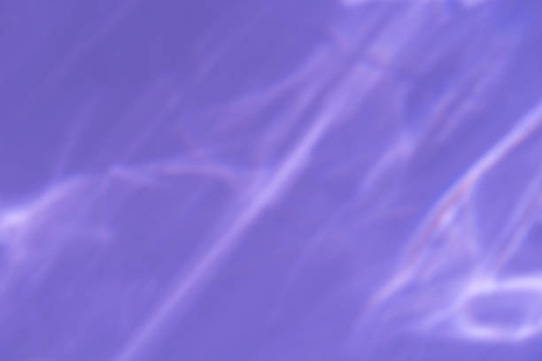 istock Caustic effect light refraction on lilac wall overlay photo mockup, blurred sun rays refracting through glass prism with shadow. Abstract natural light refraction silhouette on water surface mock up 1439491591