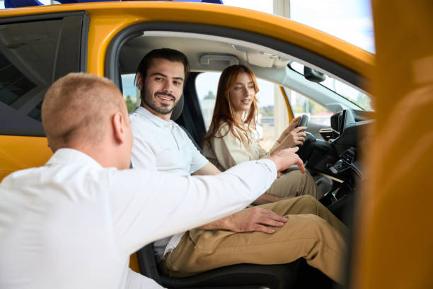 istock Auto sales consultant is advising potential customers 1439493190