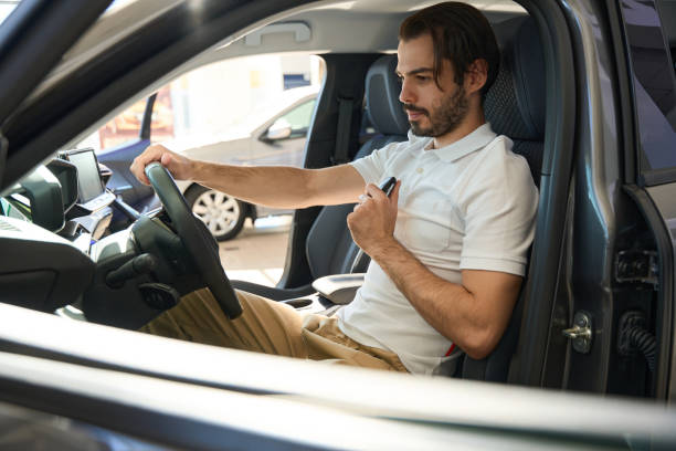 istock Concentrated auto dealership client choosing new passenger car 1439494549