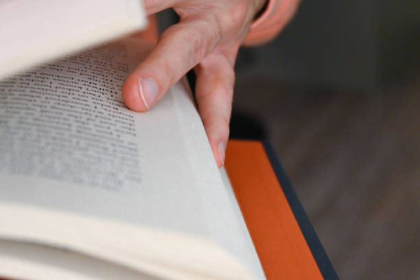 istock Close-up a person reading a book 1439495240