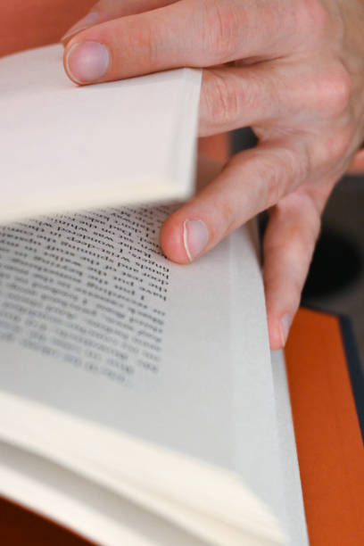 istock Close-up a person reading a book 1439495241