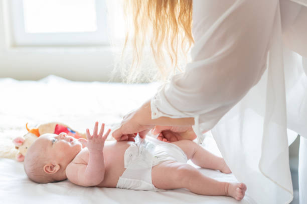 istock Mother changing the baby's diaper. Close up. 1439495844