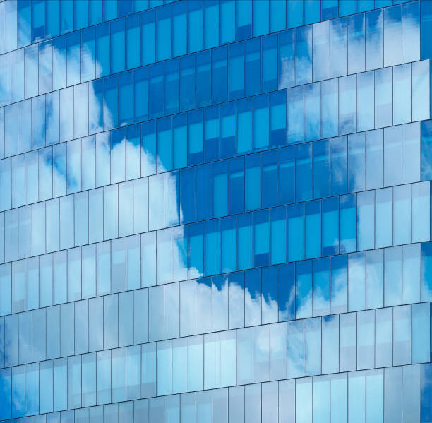 istock soft light glass wall exterior architecture building reflection cloud and blue sky clean environment background.for modern business office,ecology,smart city design. 1439496597