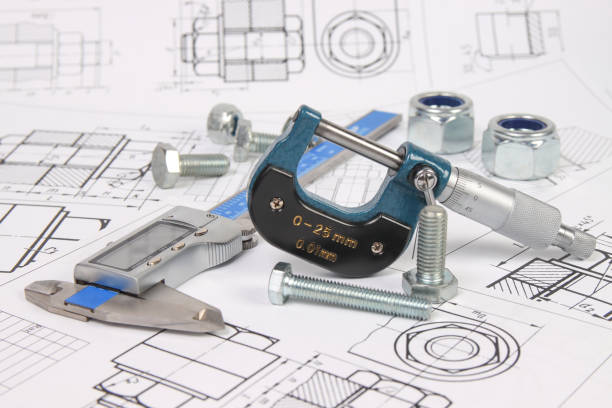 istock micrometer, caliper and hardware on a background of engineering drawings. Science, mechanics and mechanical engineering. 1439498452