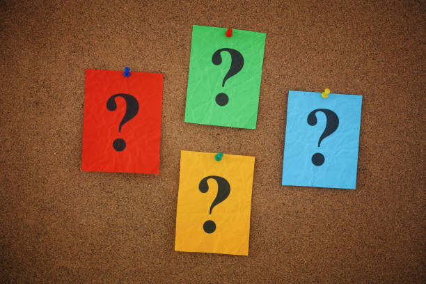 istock Colorful crumpled paper notes with question marks on them pinned to a cork board 1439499767