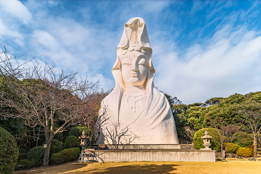 kanagawa, oofuna - 25 dec 2021: Huge white concrete statue depicting a bust of the japanese buddhist Goddess of Mercy White-robed Byakue Kannon bodhisattva in the funa Kannon Temple of Kamakura.