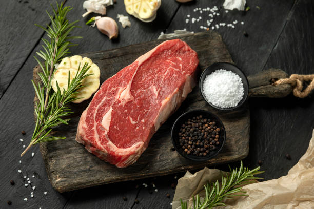 istock raw juicy rib eye on bord 1439500725