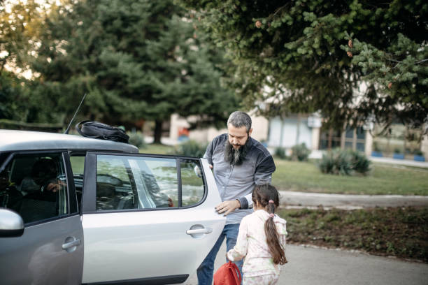 Father opening car door for child to enter