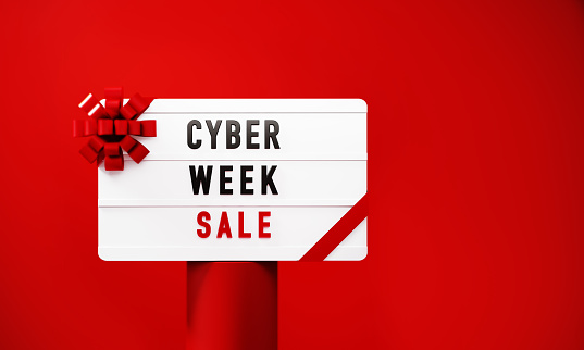 Cyber Week Sale written white lightbox sitting on red podium before red background. Horizontal composition with copy space.