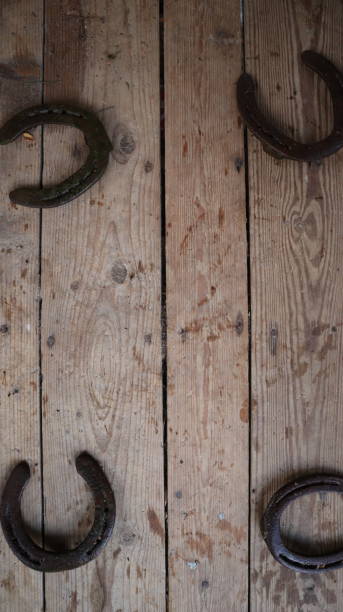 istock Horseshoes on a worn wooden surface 1439503912