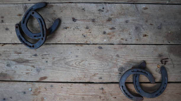 istock Horseshoes on a worn wooden surface 1439503962