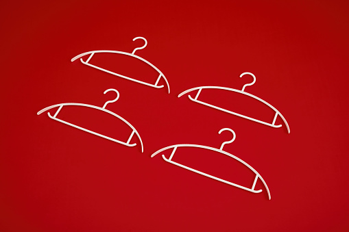 Four hangers on red background