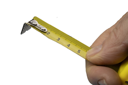 a male hand with a flexible measuring tape   on a transparent background