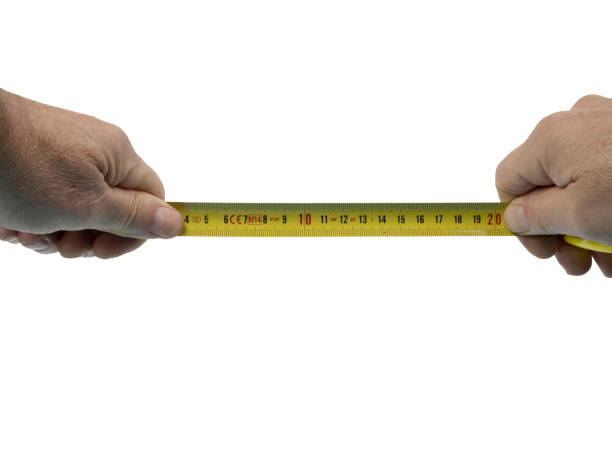 istock a male hand with a flexible measuring tape 1439510934