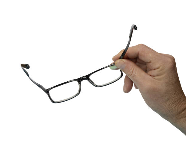 istock a pair of eyeglasses in a man's hand 1439511043