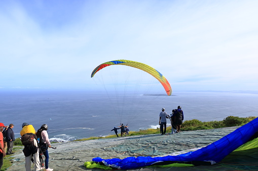 September 24 2022 - Cape Town in South Africa: Paragliders departing from Capetown signal hill