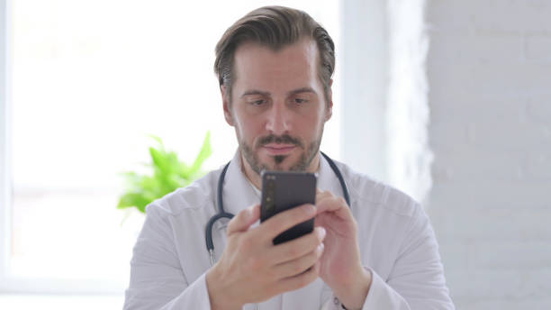 istock Portrait of Young Doctor using Smartphone 1439517404