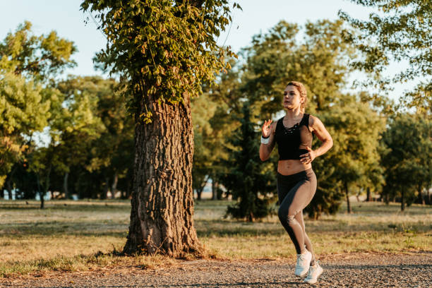 istock Young Woman Jogging In The Park 1439517702