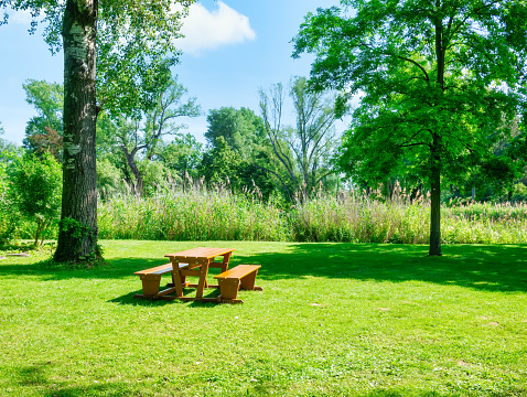 Wooden table with chairs for picninc and resting in Donau Park Vienna, Austria.