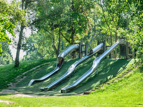 Three metal slides on a kids playground located in Donau Park Vienna, Austria.