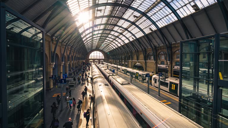 Time lapse of Crowded Commuter people left and walk out from train arrive in Kings Cross Station platform