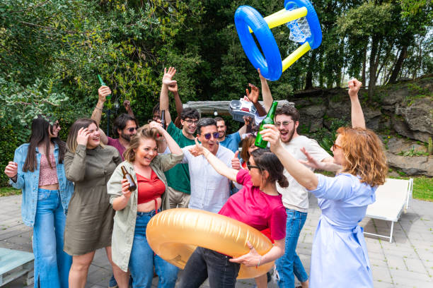 istock Multicultural friends group having fun out side cheering with boombox and beer bottle 1439521696
