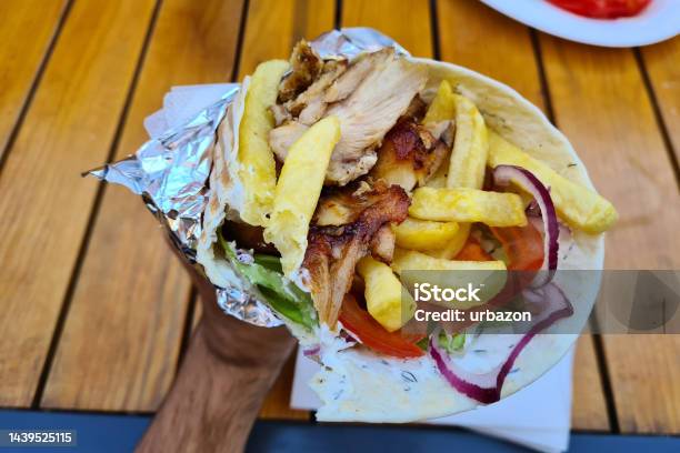 Young Man Holding Greek Gyros Stock Photo - Download Image Now - Barbecue Grill, Beef, Bread