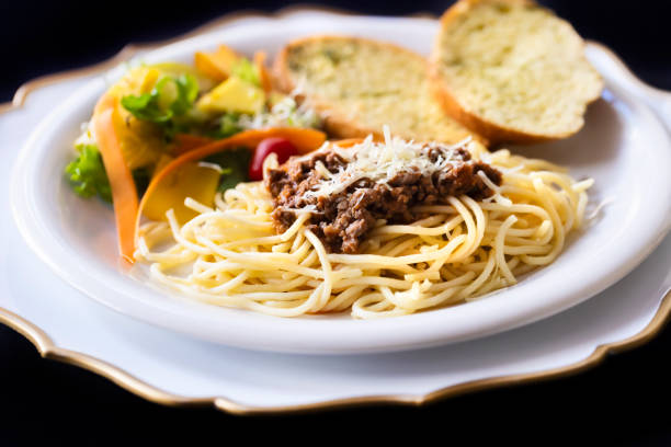 Pasta Bolognese dish on black background