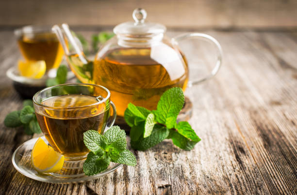 istock Fresh mint tea with lemon on the wooden table 1439527312