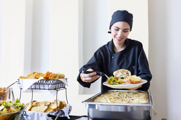 istock Young cook serving food 1439528023