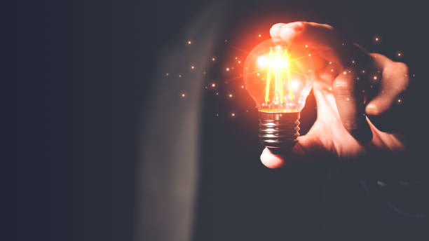 istock Man's hand holding a light bulb. Ideas, innovations and inspiration. Creative idea with sparkling light bulbs. concept of crisis 1439529066