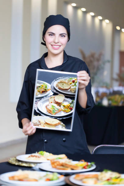 istock Latin chef holding a mirror reflecting the dishes on the table. 1439529644