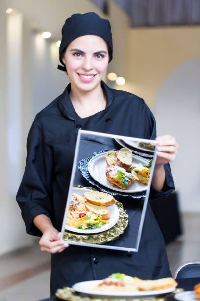 istock Chef holding a mirror reflecting the dishes on the table. 1439529672