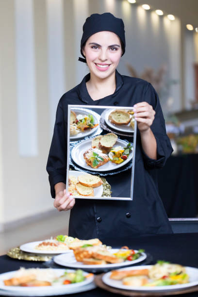 istock Young chef holding a mirror reflecting the dishes on the table. 1439530129