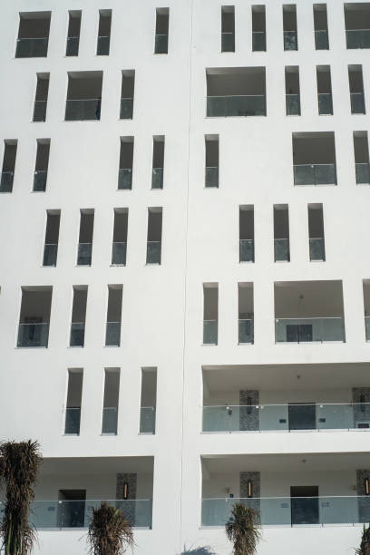 New modern apartment building and old houses, white background with copy space, full frame horizontal composition