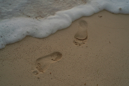 Foot print in Sand with Waves