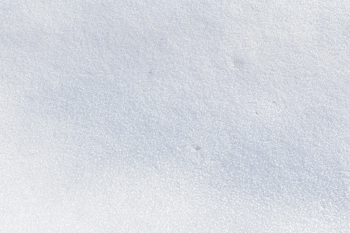 White snow texture on clear day. Winter background. Snow drifts. white snowflakes background, pattern of snow texture