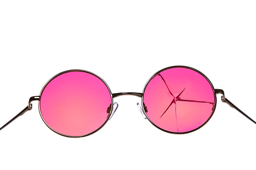 Round sunglasses with pink cracked  glasses with a gradient in a metal frame on a white background, isolated. See the world, things through rose-colored glasses