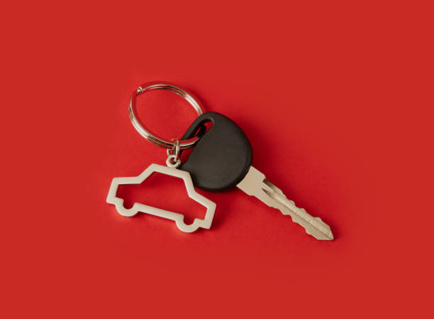 car key with keychain on red background
