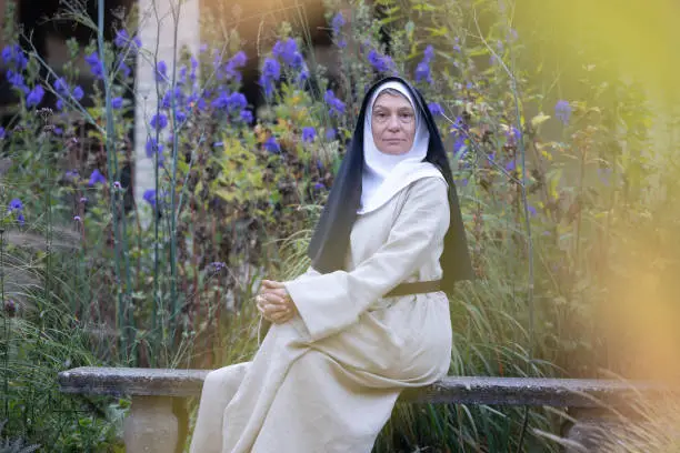 Walking nun in monastery and garden