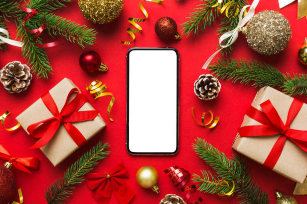 istock Digital phone mock up with rustic Christmas decorations for app presentation top view with empty space for you design. Christmas online shopping concept. Tablet with copy space on colored background 1439537134