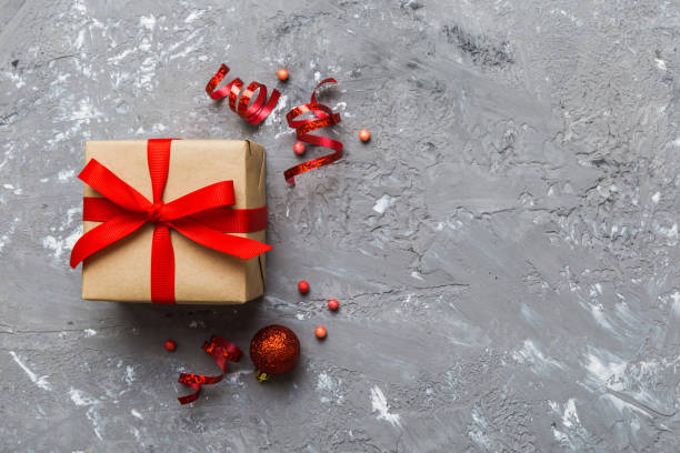 istock Top view Flat lay Christmas decorations and gift box on colored background with copy space. Christmas or Happy New Year composition 1439537318
