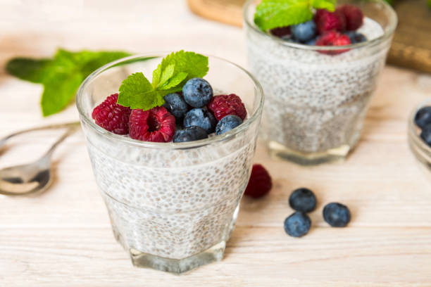 istock Healthy breakfast or morning with chia seeds vanilla pudding raspberry and blueberry berries on table background, vegetarian food, diet and health concept. Chia pudding with raspberry and blueberry 1439537795