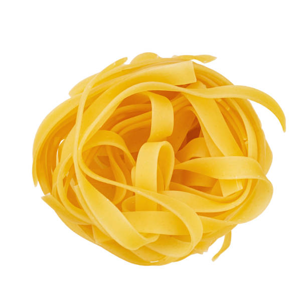 istock Raw rolled tagliatelle shape of italian pasta isolated on white background. 1439537897