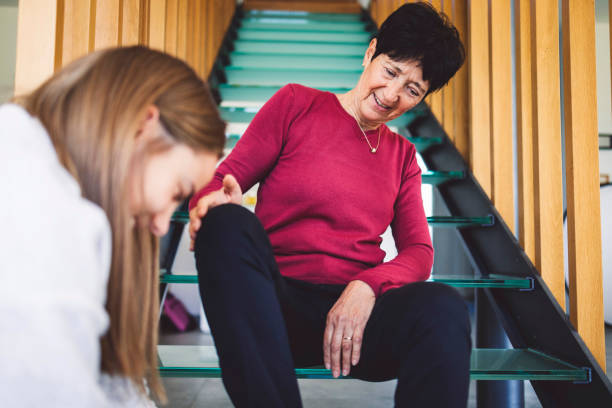 istock A caregiver ties an elderly person's shoes 1439541667