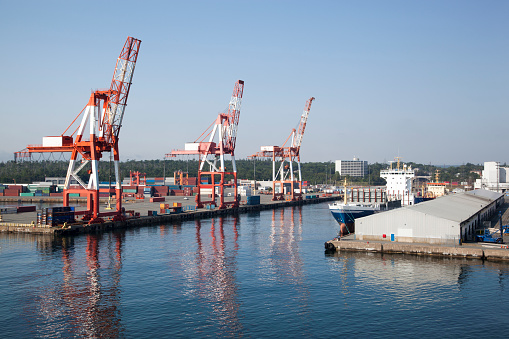 Aerial view of the marine leg of a grain elevator, shunting yard & container port in the distance.