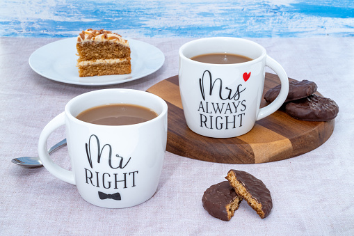 Two white mugs, one for Mr Right and the other for Mrs Alway Right with cake and cookies.